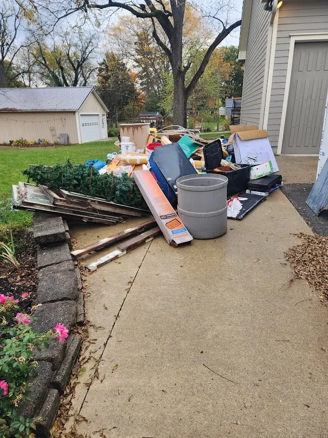 Dumpster being loaded with debris for Commercial Dumpster Rental in Grambling